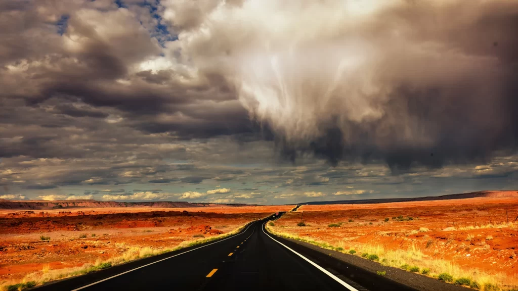 Storm clouds over a highway in the wild west